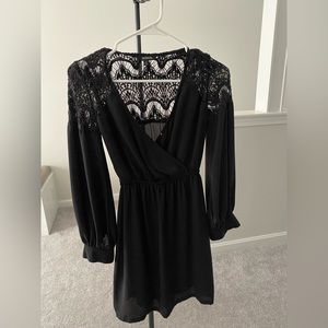 Black flowy mini dress with v-neck and lace back detail